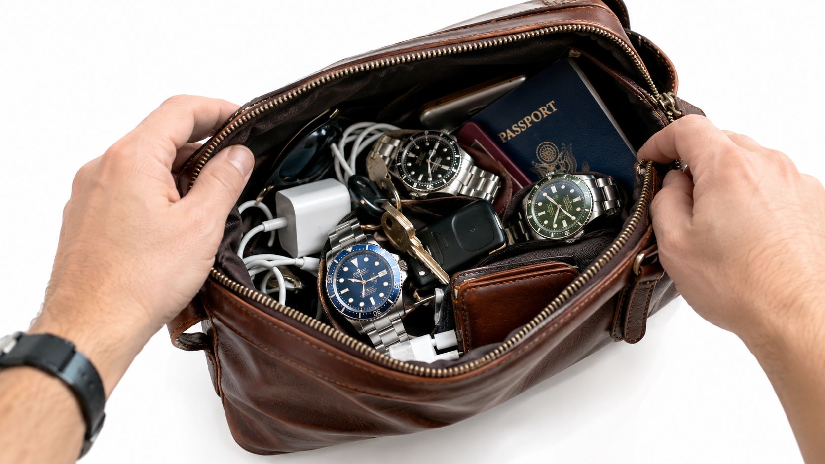 A person holds open a brown leather travel organizer bag filled with luxury watches and travel essentials.