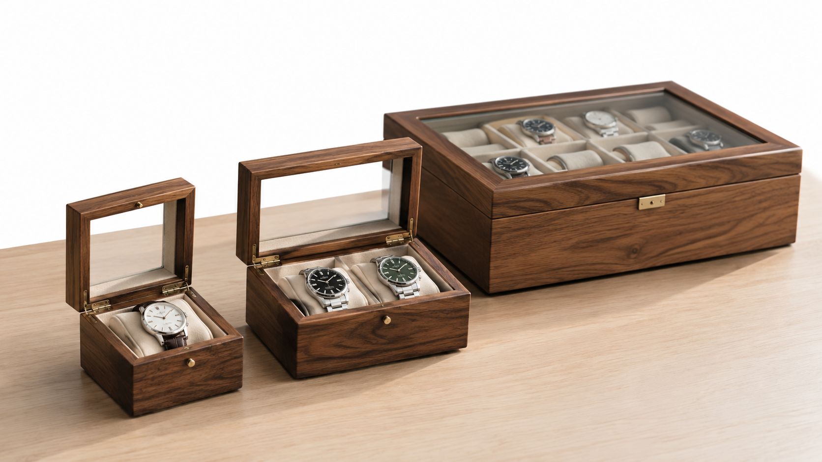 A collection of wooden watch display cases containing various luxury wristwatches on a light wooden table surface.