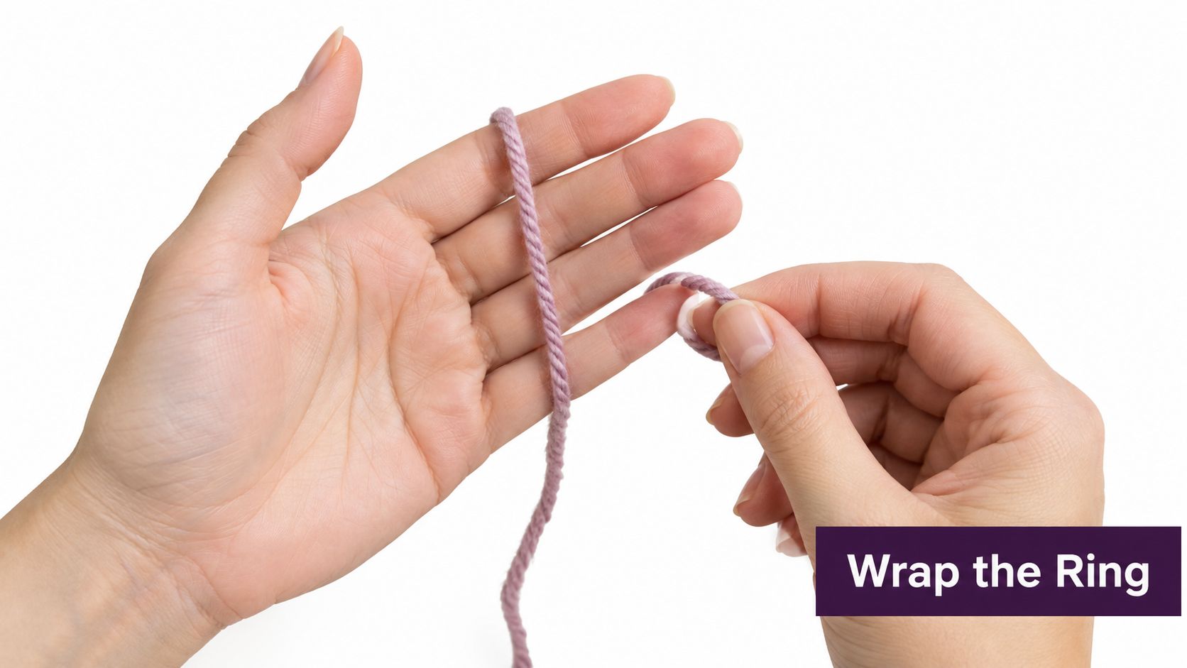 A close-up view of hands holding purple yarn, demonstrating how to wrap a ring for crochet.
