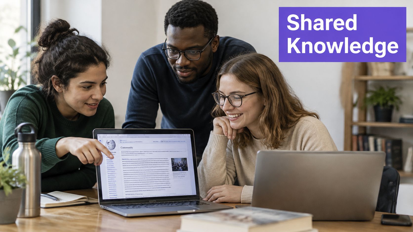 A diverse team of three students working together on a collaborative project using a laptop computer.