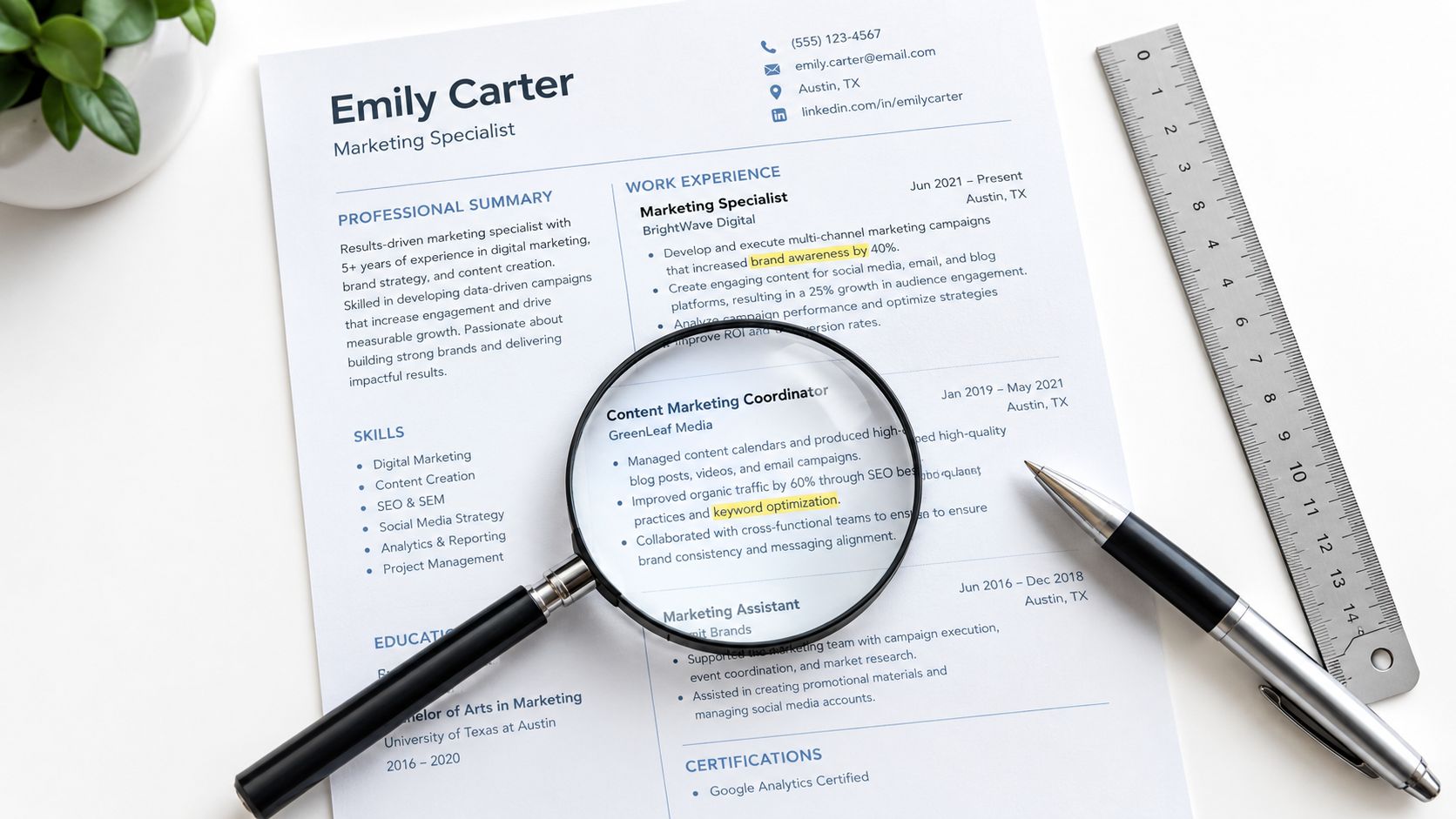 A professional marketing specialist resume on a desk with a magnifying glass, pen, and metal ruler.