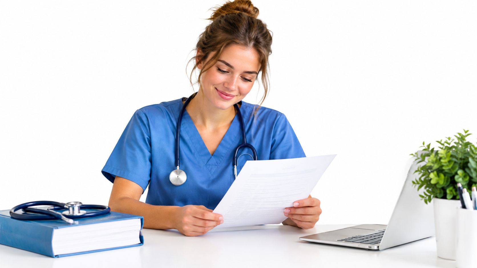 A professional nurse in blue scrubs reviewing medical documents at a desk with a stethoscope and laptop.