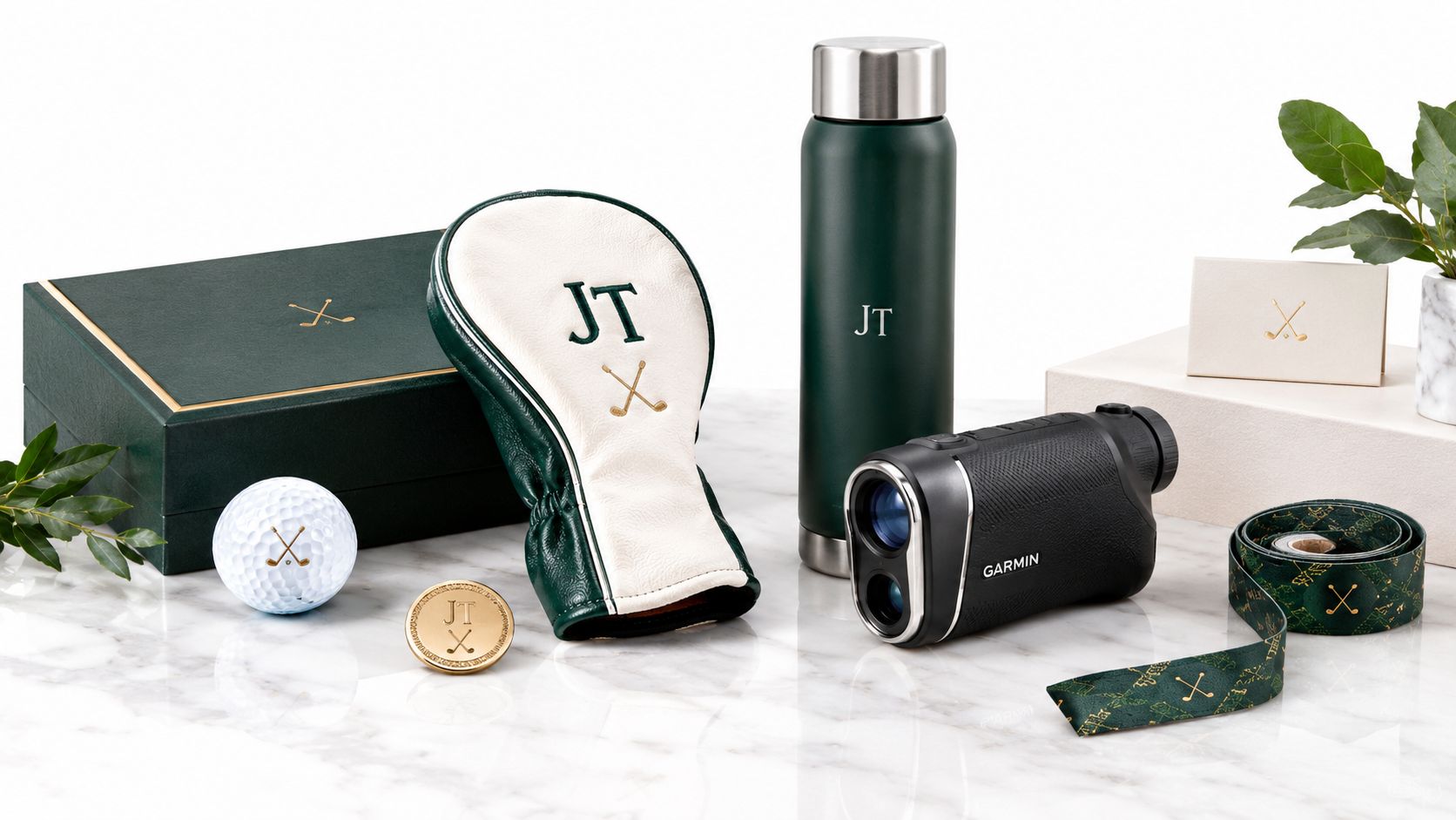 A collection of personalized golf gift items arranged neatly on a white marble tabletop surface.