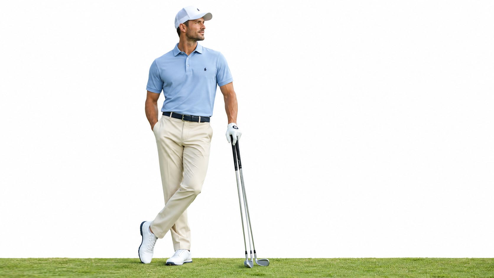 A professional golfer standing on grass wearing a light blue polo shirt and beige golf trousers.