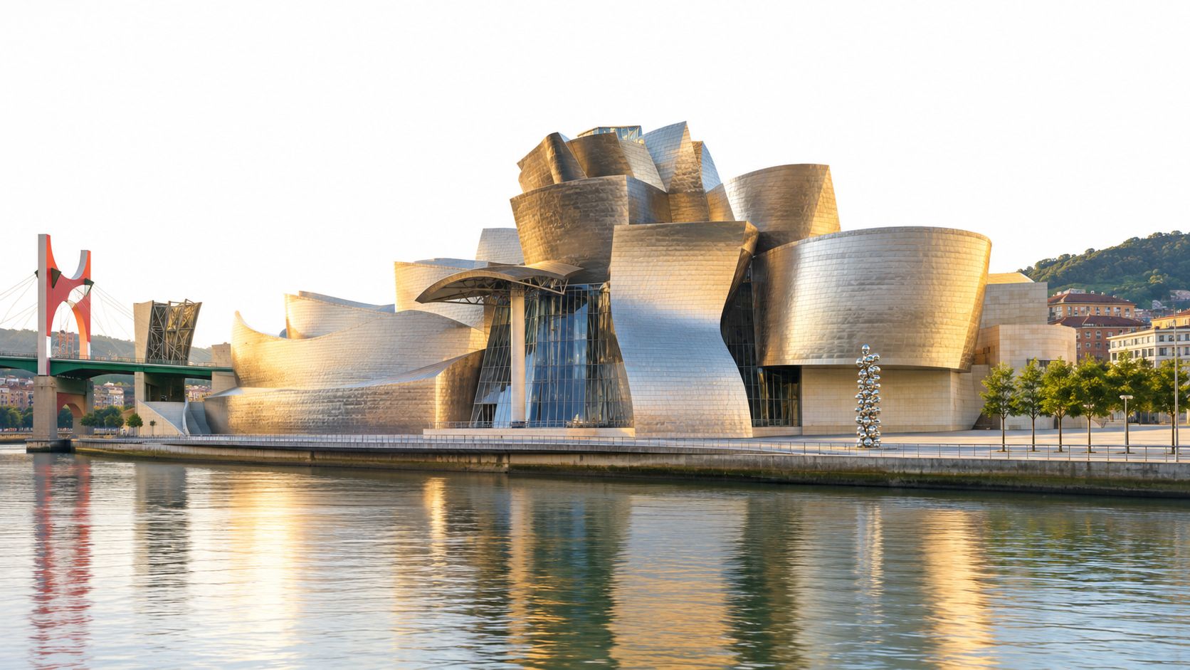 The Guggenheim Museum Bilbao, an iconic modern architectural masterpiece made of titanium, situated by the Nervión River.