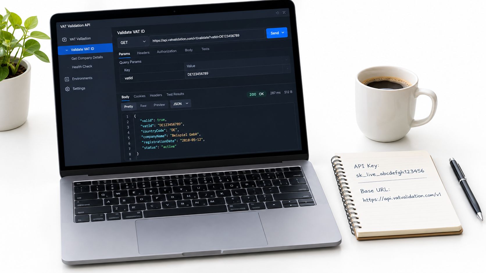 A laptop displaying a VAT validation API interface with code results next to a notebook and coffee.