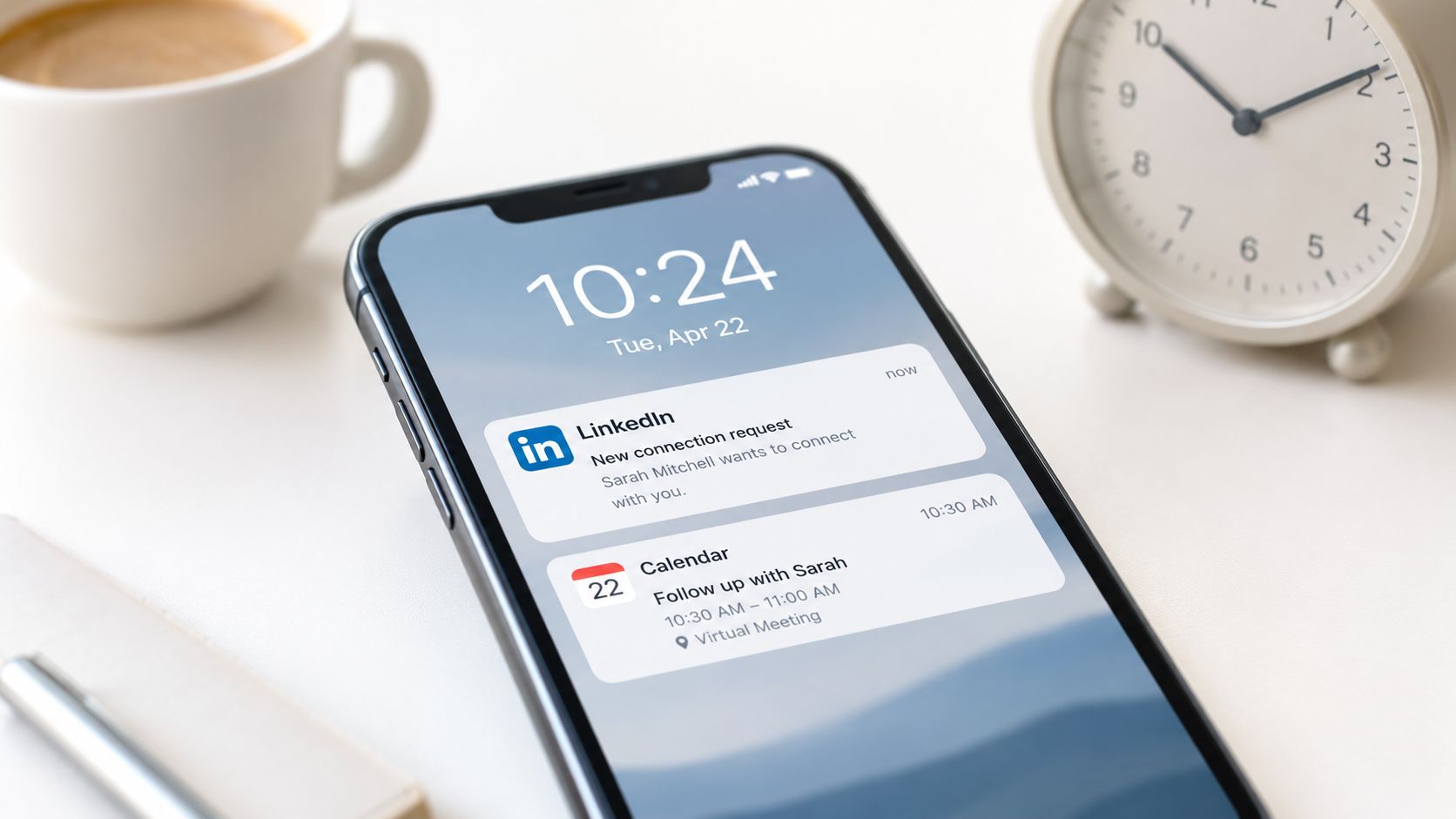 A smartphone screen showing a LinkedIn connection request and a calendar reminder notification on a desk.