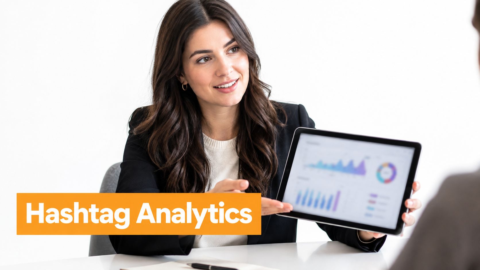 A professional woman in a business suit showing analytics data on a tablet during a business meeting.