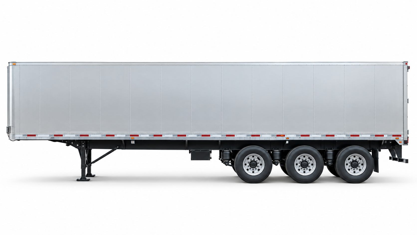 A side view of a large silver semi-trailer with three axles parked against a white background.