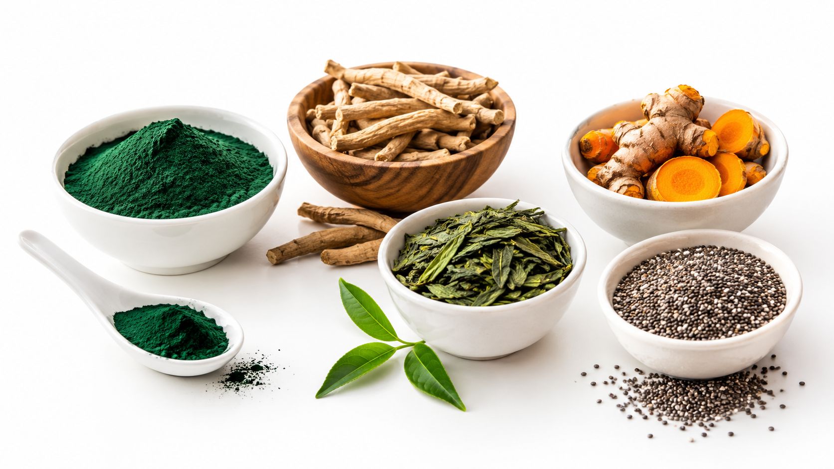 A selection of natural plant-based supplements including spirulina powder, turmeric roots, ashwagandha, green tea leaves, and chia seeds.