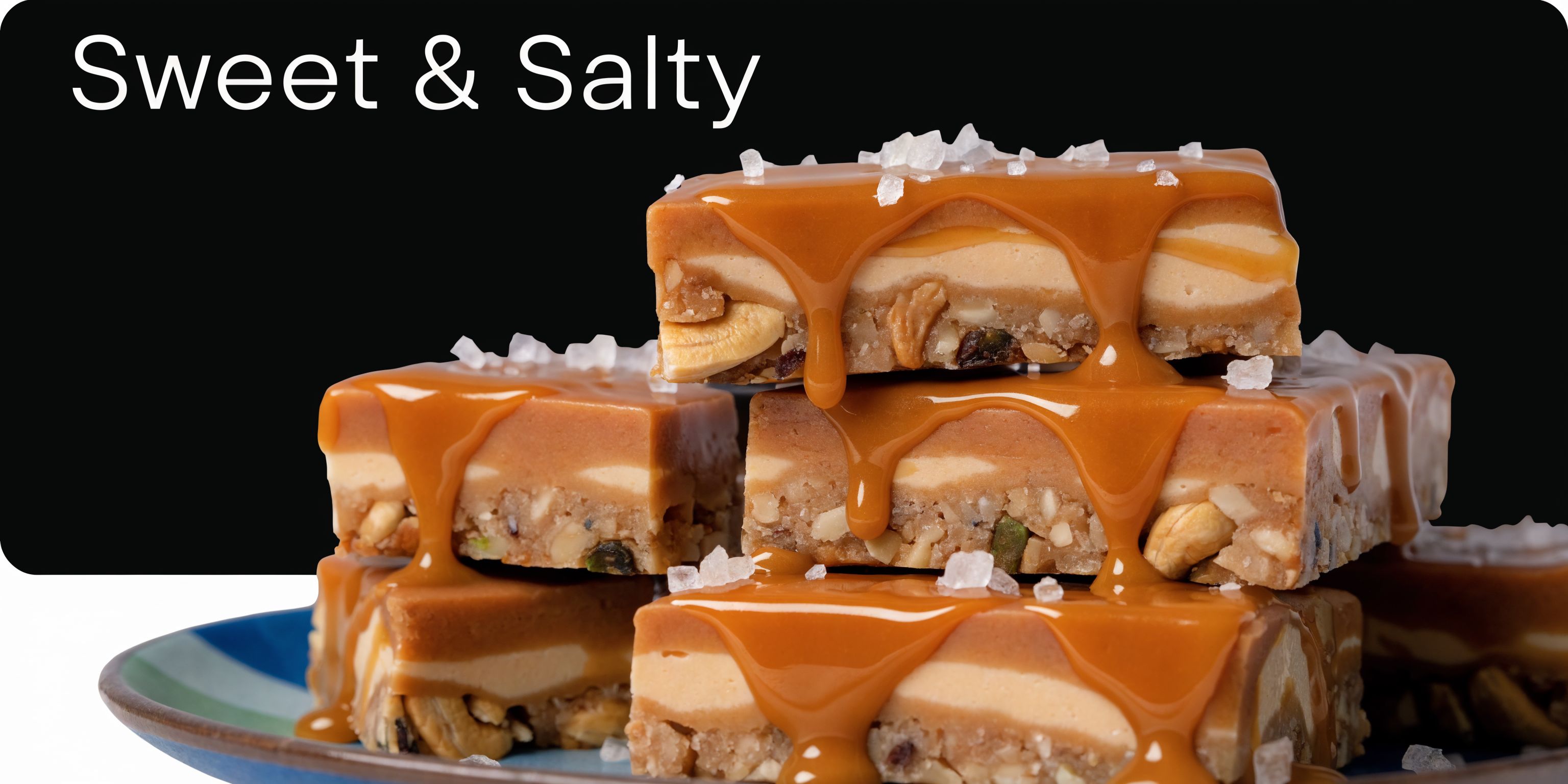 A stack of decadent salted caramel protein bars topped with sea salt and dripping with caramel sauce.