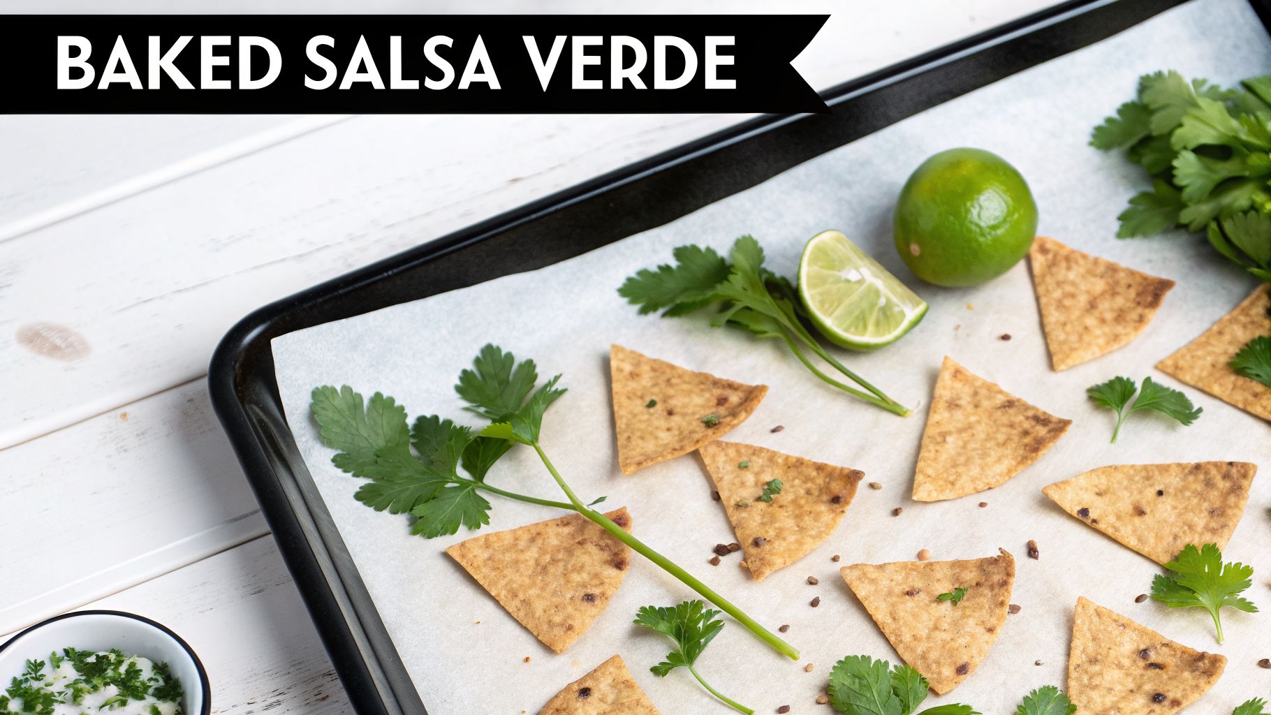 Baked salsa verde tortilla chips with fresh cilantro and lime on a parchment-lined baking sheet.