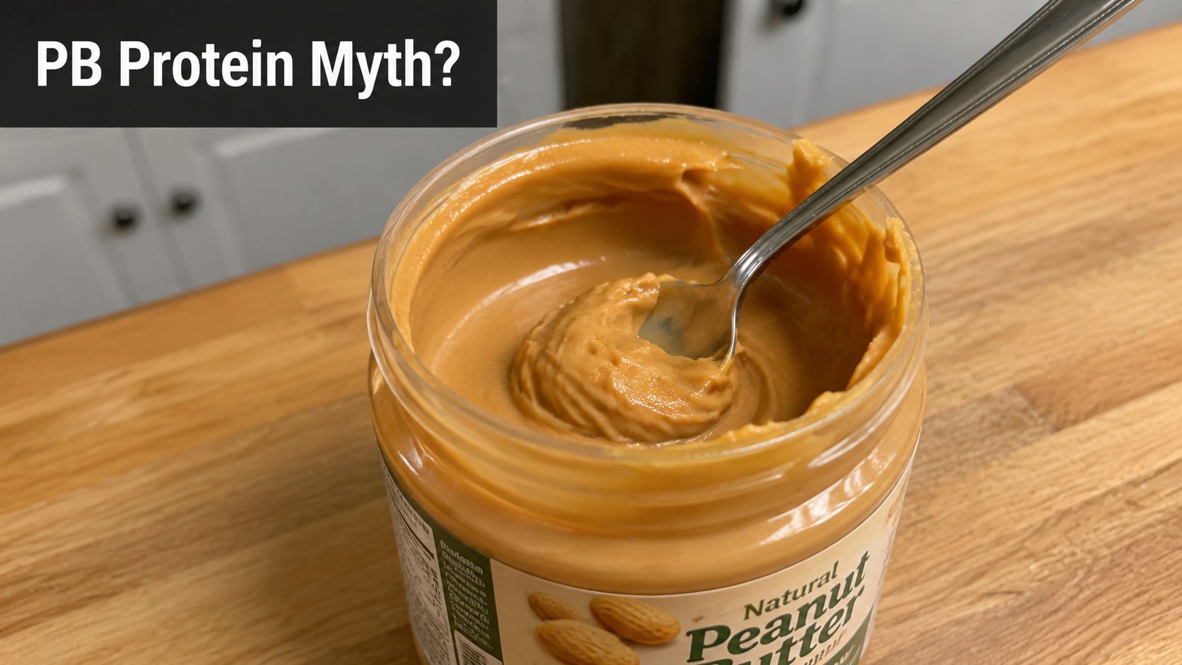 A close-up shot of an open jar of natural peanut butter with a spoon resting inside.