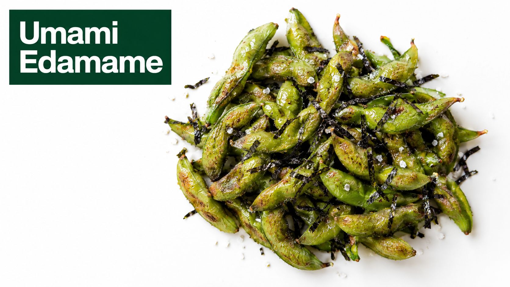 A top-down view of a pile of pan-seared edamame beans seasoned with salt and shredded seaweed.