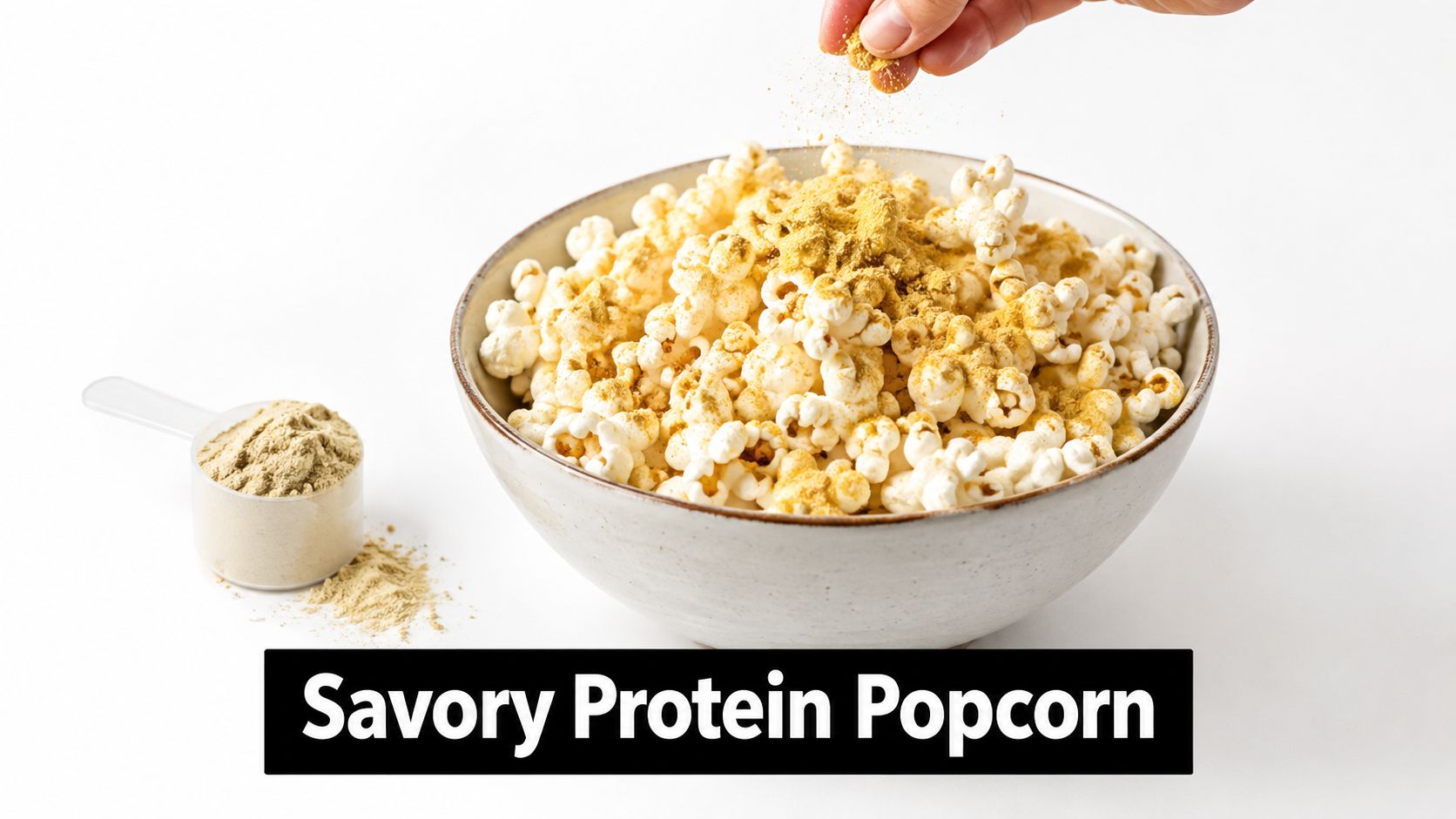 A hand sprinkles seasoning over a large bowl of fresh popcorn, with a protein powder scoop nearby.