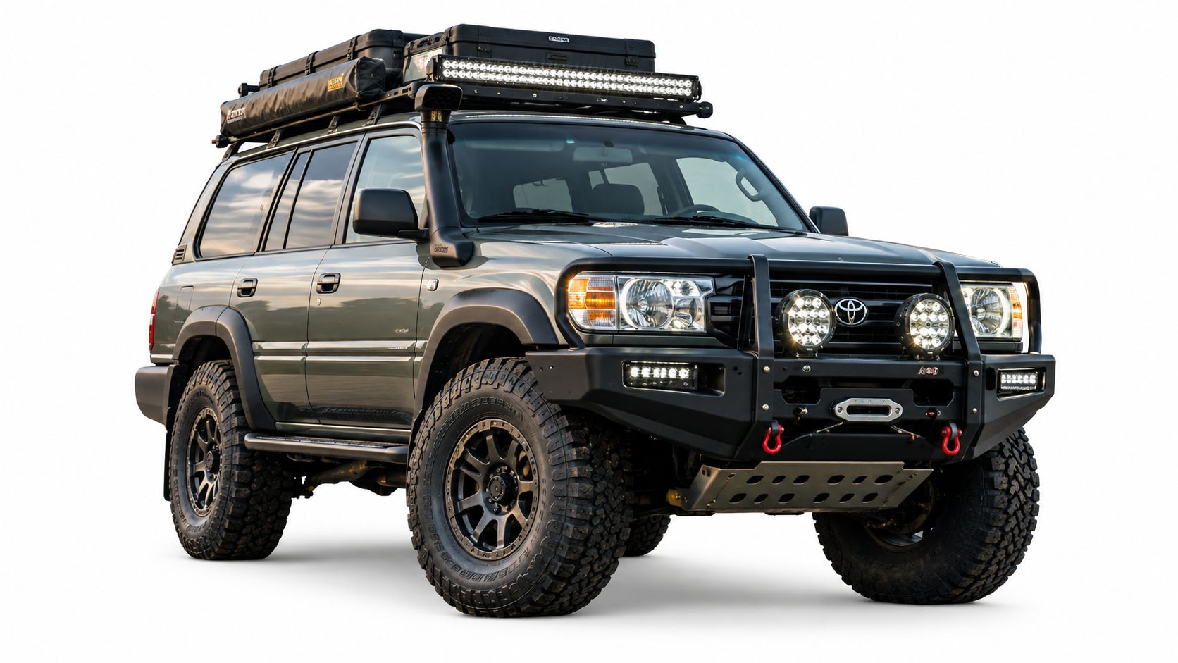 A modified green Toyota Land Cruiser off-road vehicle with a roof rack and bull bar, isolated against white.