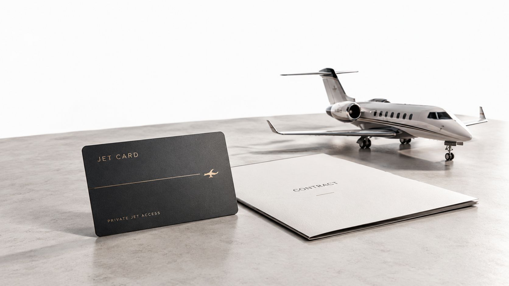 A black jet card, a contract document, and a model airplane on a textured gray surface.