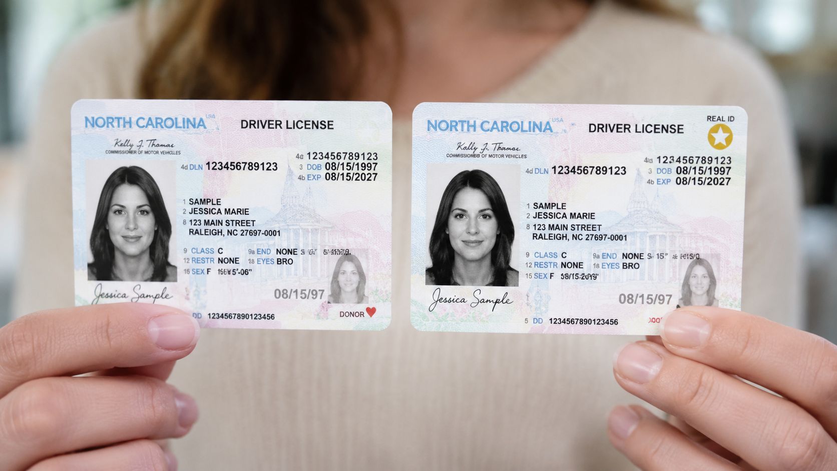 A person holding two North Carolina driver's licenses, comparing a standard license with a Real ID version.