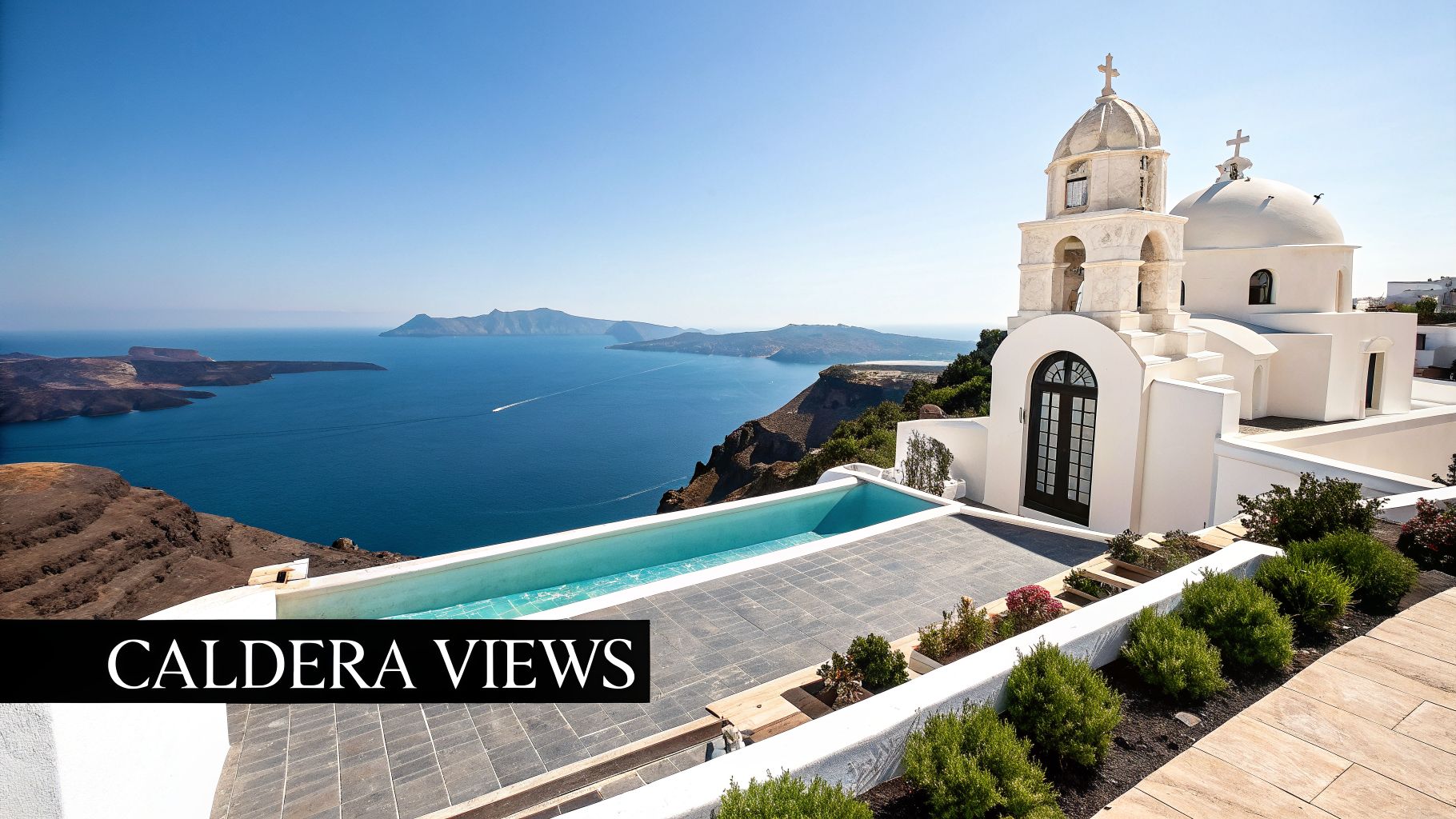 A stunning white church and infinity pool overlook the blue caldera sea and islands on a sunny day.