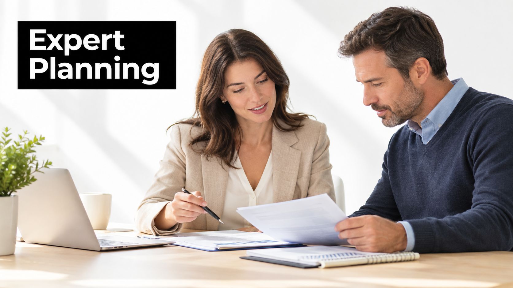 A professional travel consultant and a client reviewing documents and travel planning details at an office desk.