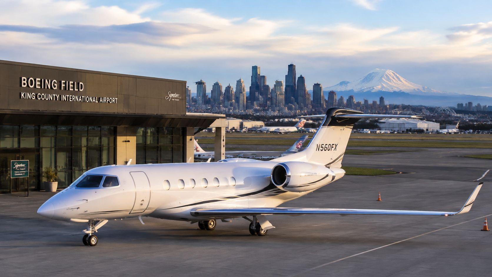 A luxurious private jet parked on the tarmac at Boeing Field in Seattle with the skyline visible.