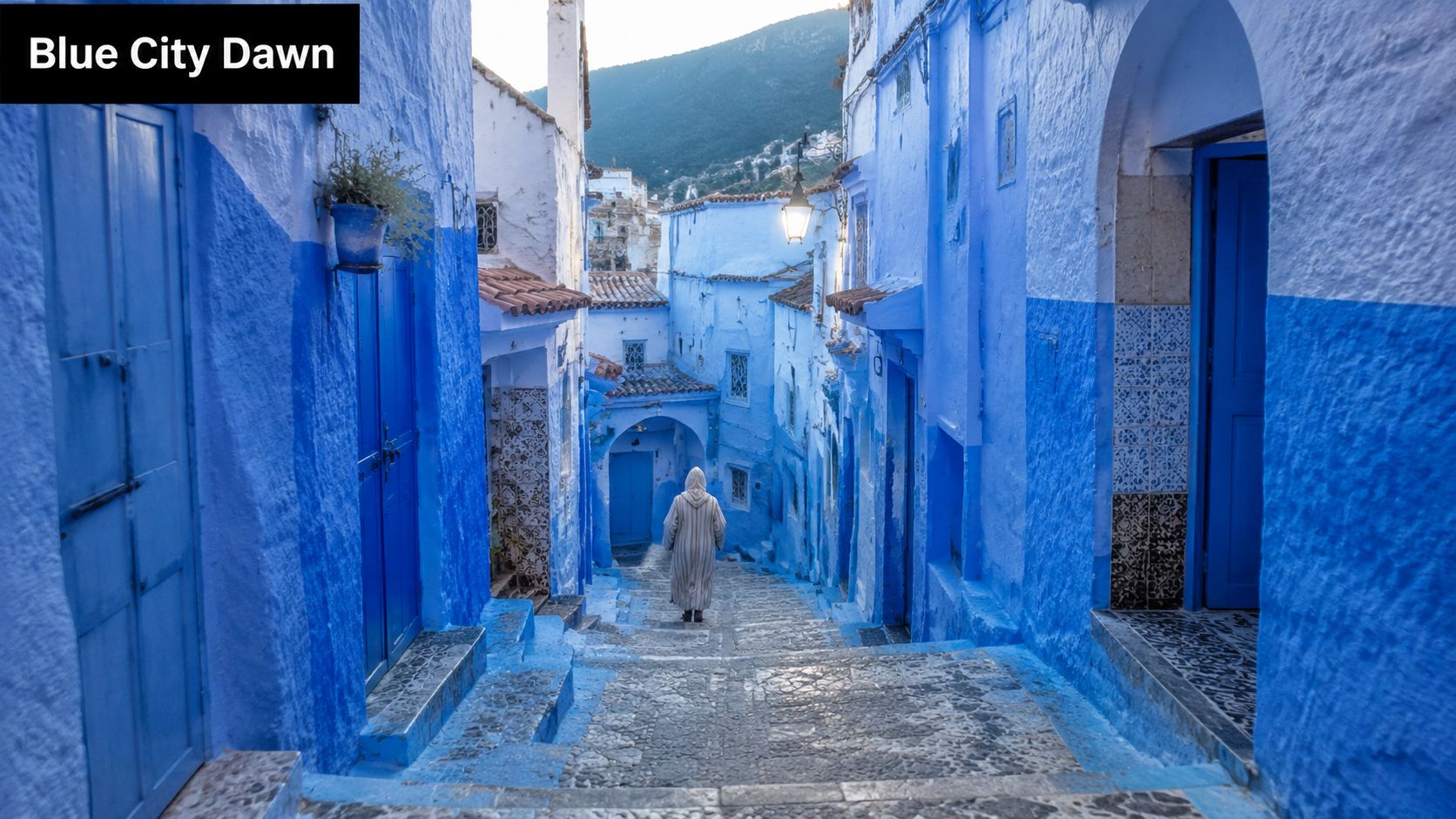 A person in traditional clothing walks down a narrow, sunlit street in the blue city of Chefchaouen, Morocco.