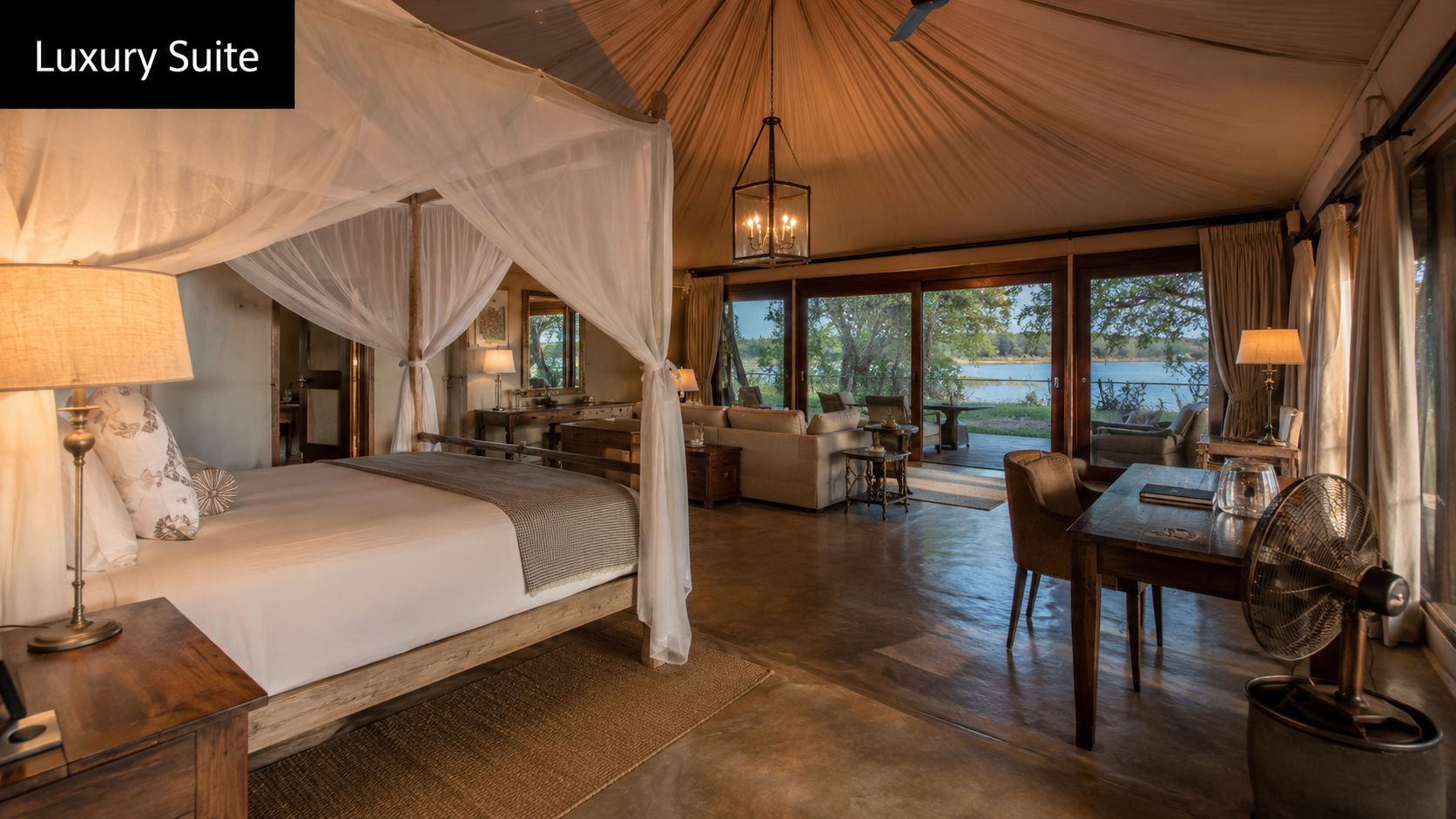A luxurious tented safari suite in Botswana features a canopy bed, desk, and panoramic views of water.