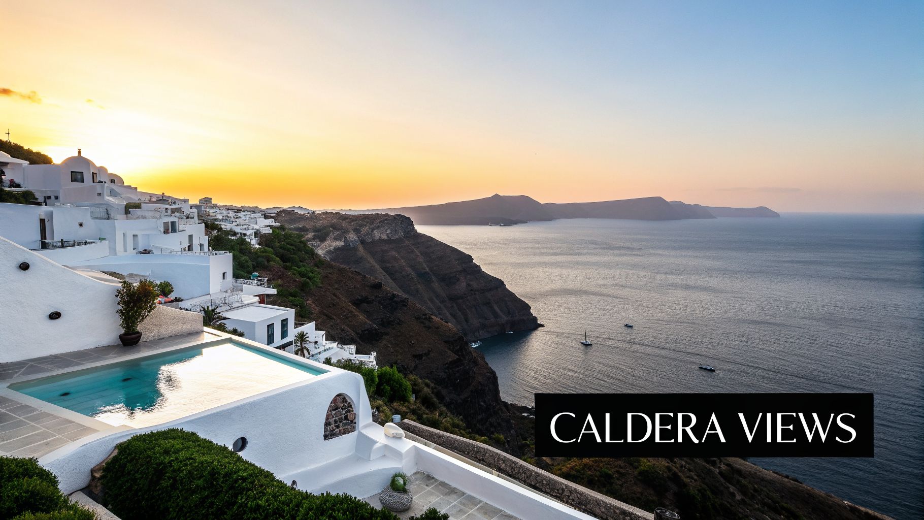 Stunning sunset over white buildings and an infinity pool in Santorini, overlooking the caldera and sea.