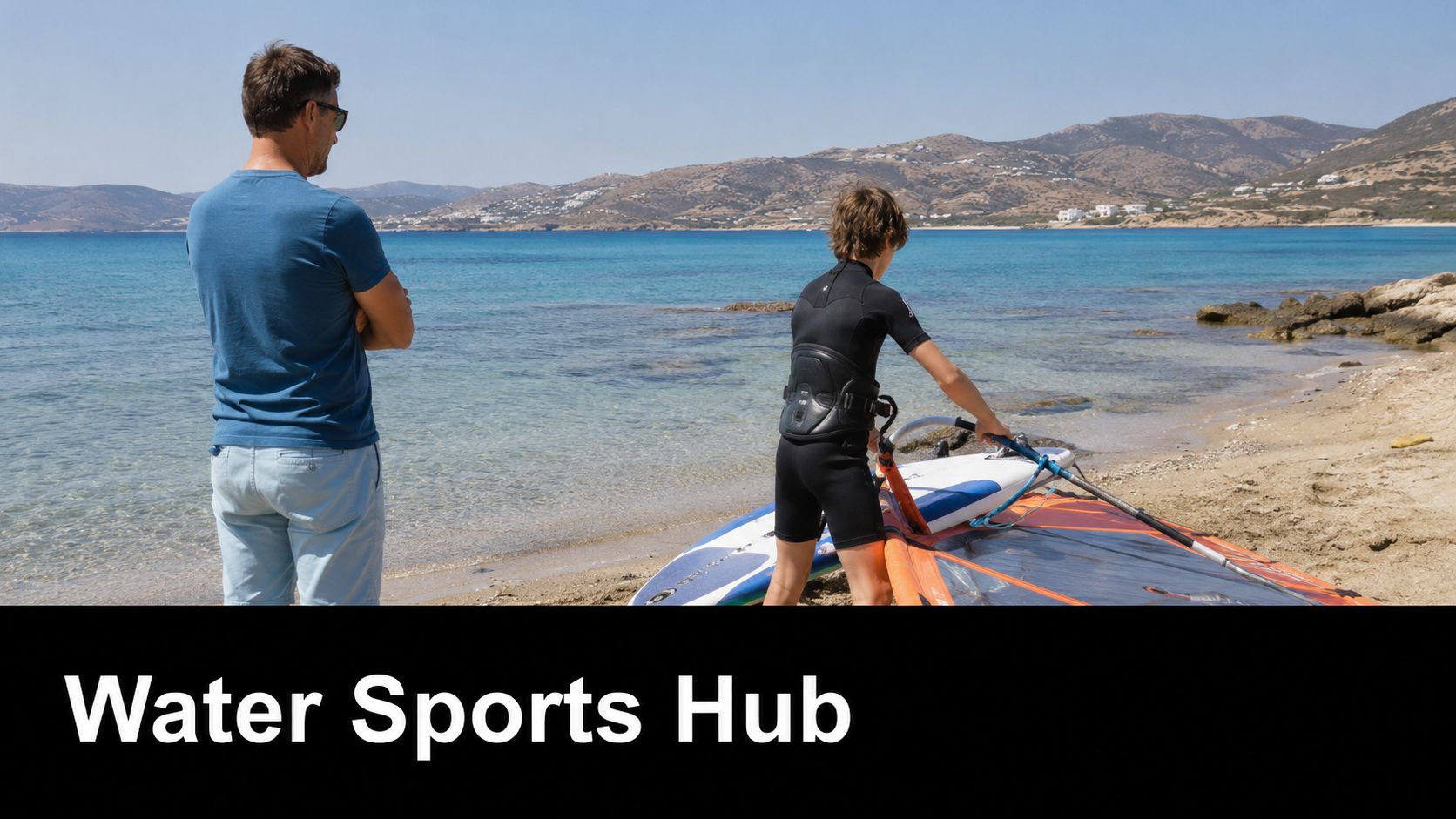A father and son preparing for windsurfing together on a sunny beach in the Greek islands.
