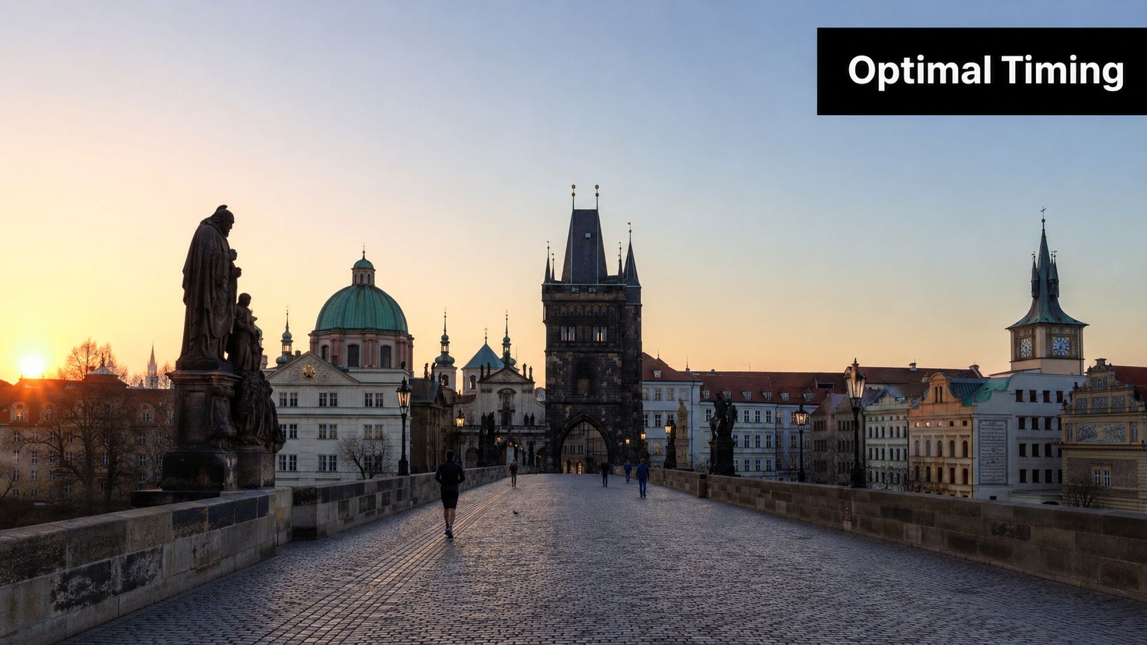 A scenic view of the historic Charles Bridge in Prague during a golden sunrise with city architecture.