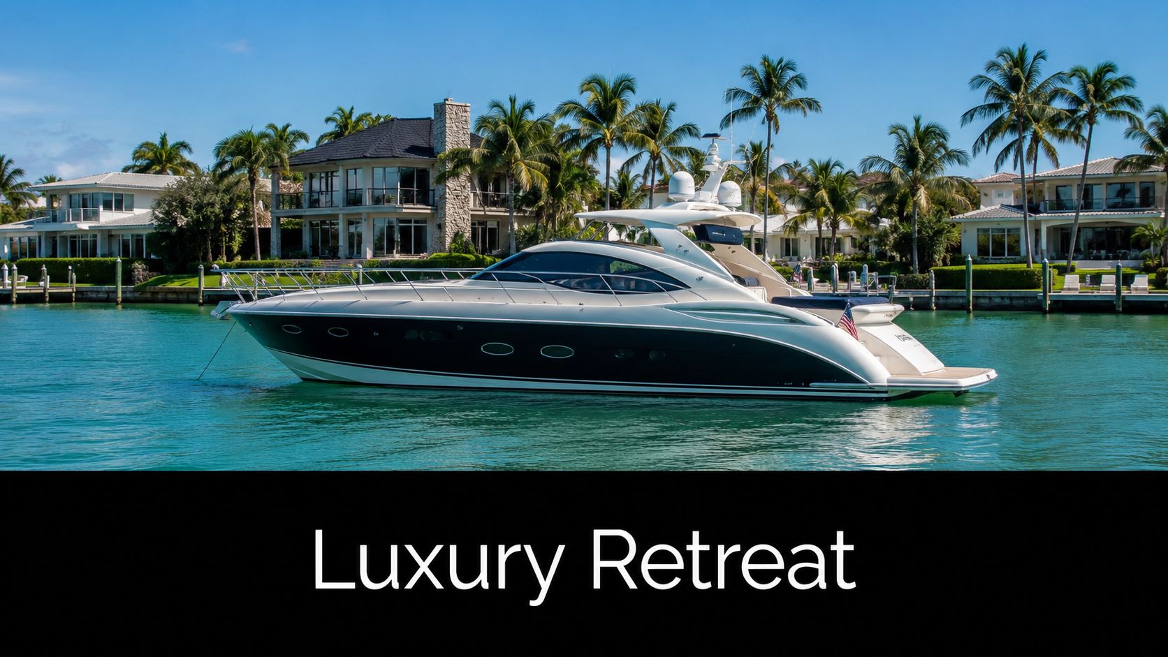 A luxurious yacht anchored in calm turquoise water in front of beautiful waterfront homes and palm trees.