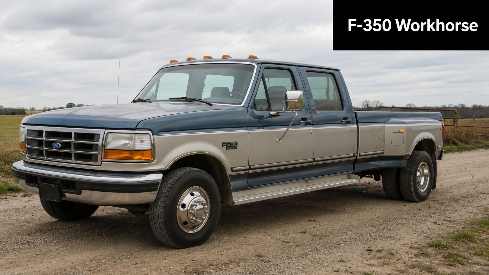 A classic blue and silver 1993 Ford F-350 crew cab dually pickup truck parked on a rural road.