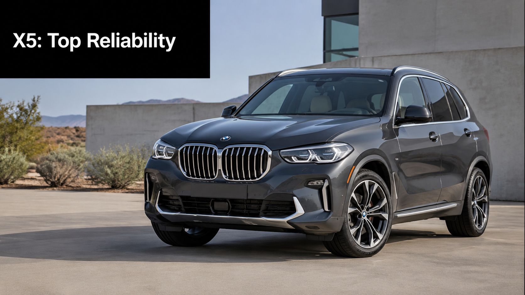 A modern grey BMW X5 SUV parked outdoors on a sunny day with architectural elements in the background.