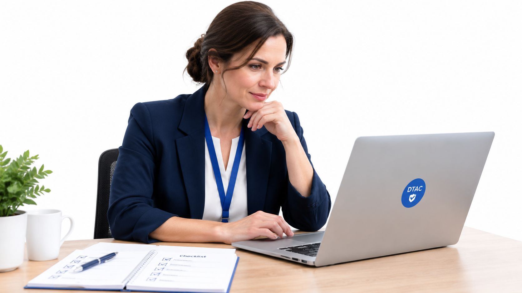 A professional woman working on a laptop with a DTAC compliance logo at her office desk.