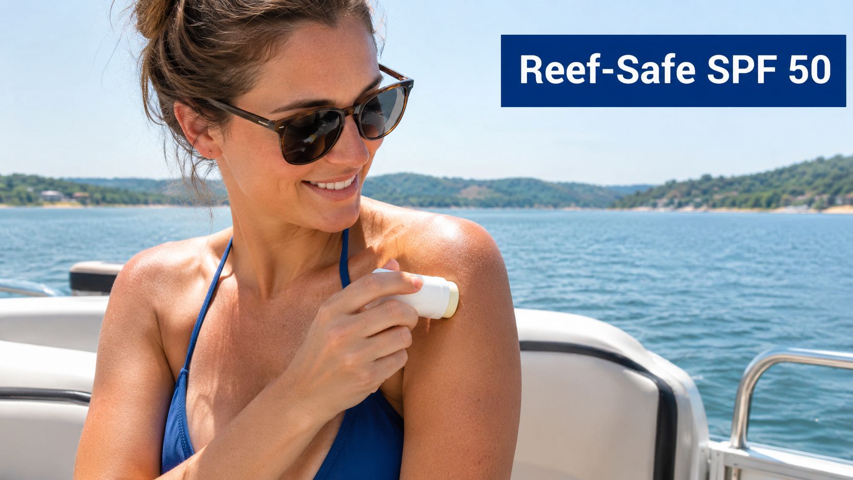A woman wearing sunglasses applying reef-safe SPF 50 sunscreen stick to her shoulder while on a boat.