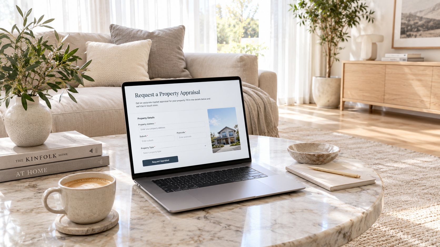 A laptop on a marble coffee table displaying an online property appraisal form in a cozy living room.
