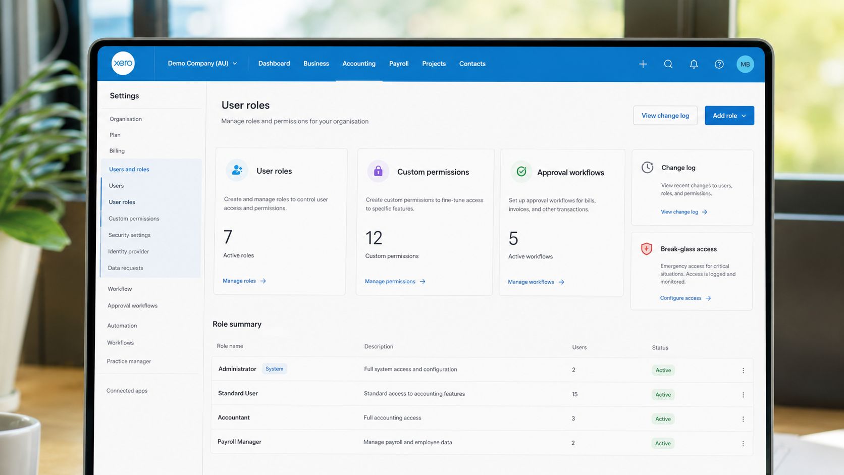 A computer screen displaying Xero accounting software settings for user roles, permissions, and approval workflows in an office.