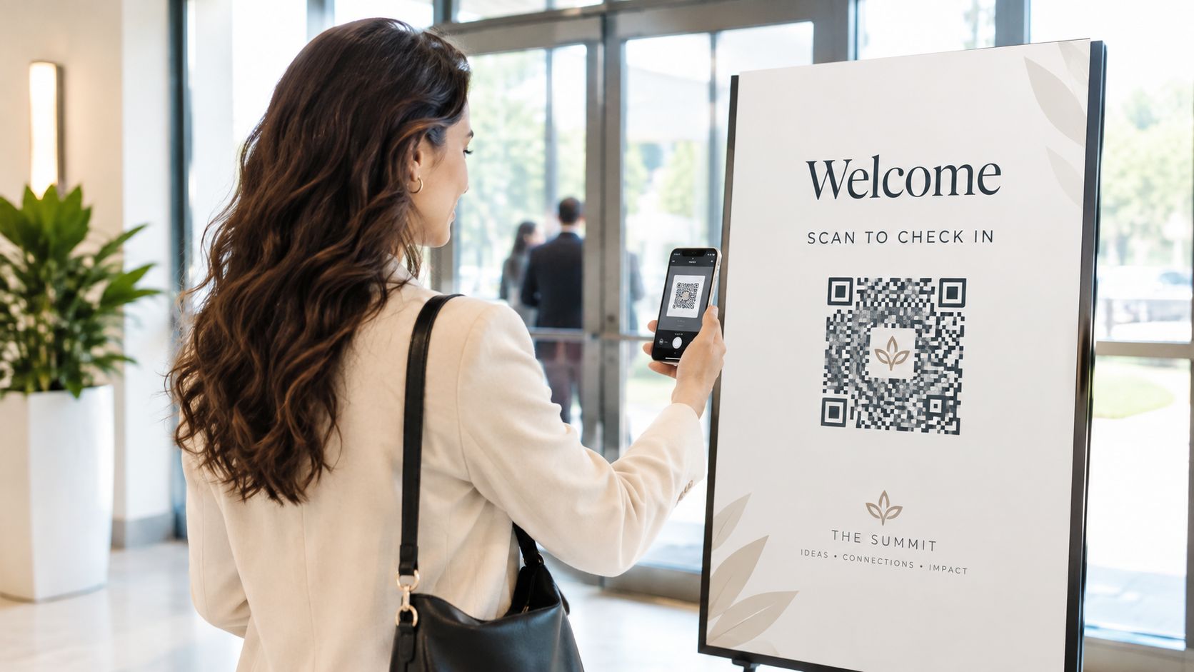 A woman uses her smartphone to scan a branded QR code on a welcome sign at an event.