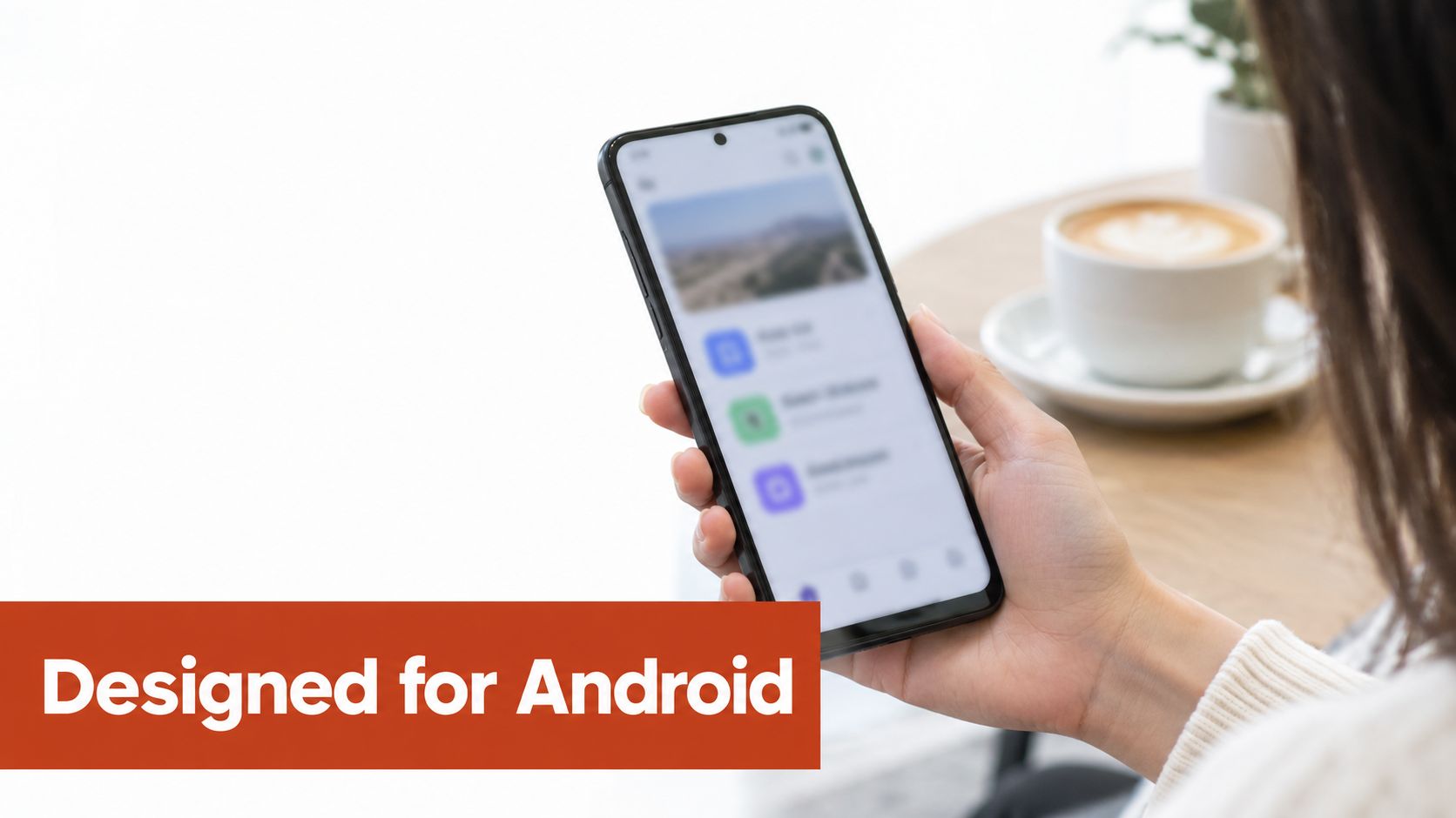 A person holding a smartphone showing an application interface with a coffee cup in the background.