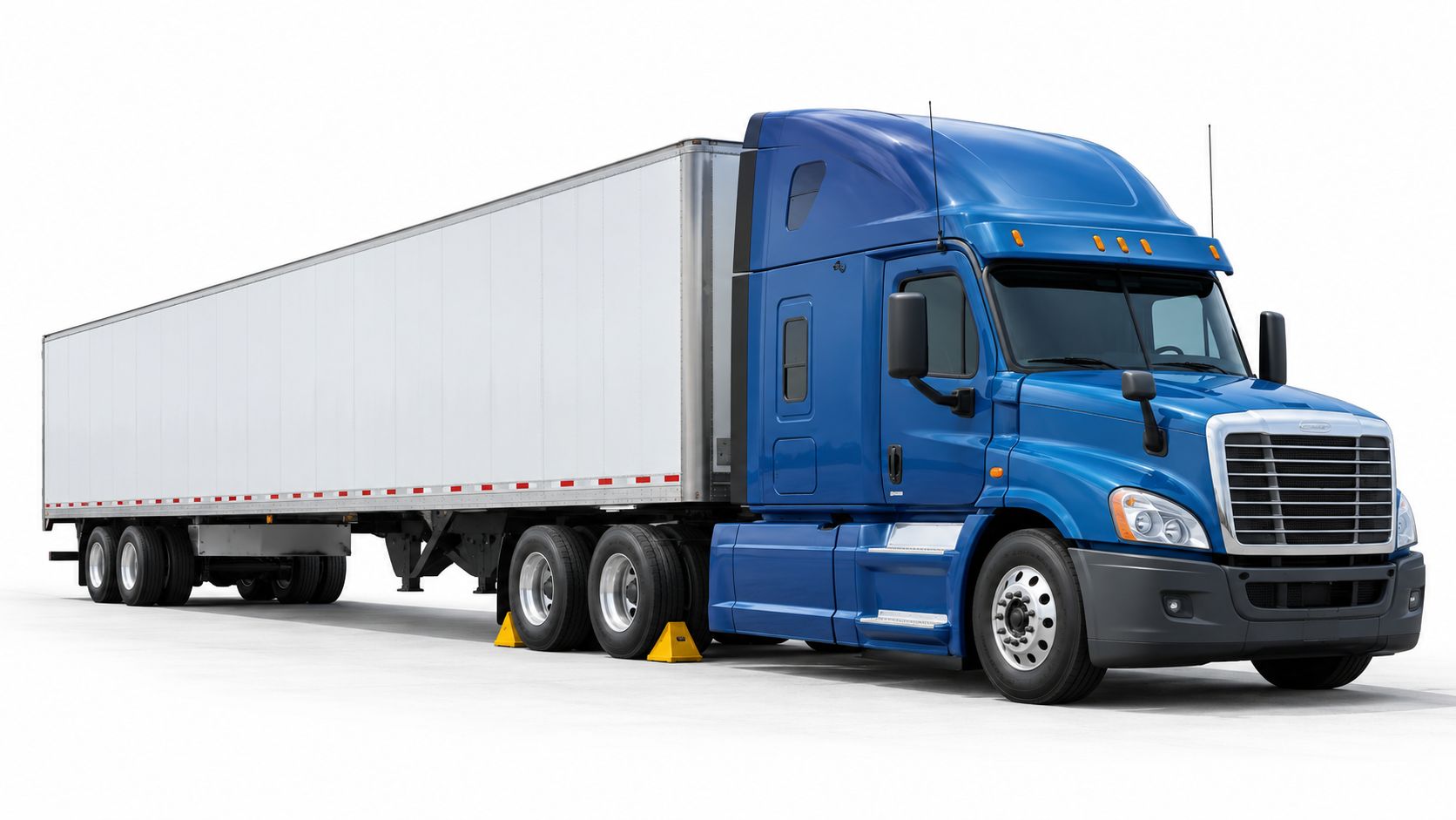 A blue semi-truck with a white trailer parked on a white background with wheel chocks installed.