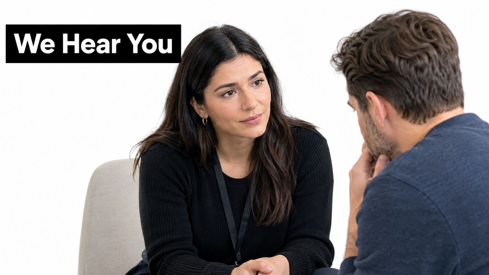 A professional woman listens attentively to a man during a supportive consultation in an office setting.