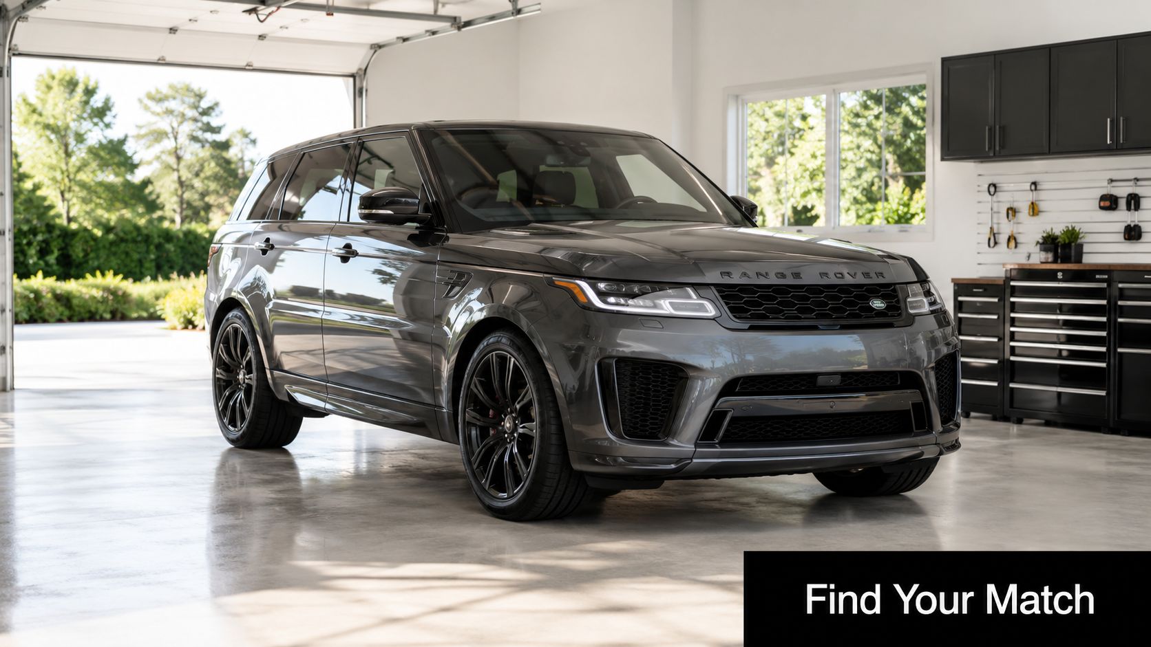 Best SUV in Dubai 2026: Top Picks by Lifestyle and Budget 3 A luxurious dark grey Range Rover SUV parked inside a clean, modern residential garage with open doors.