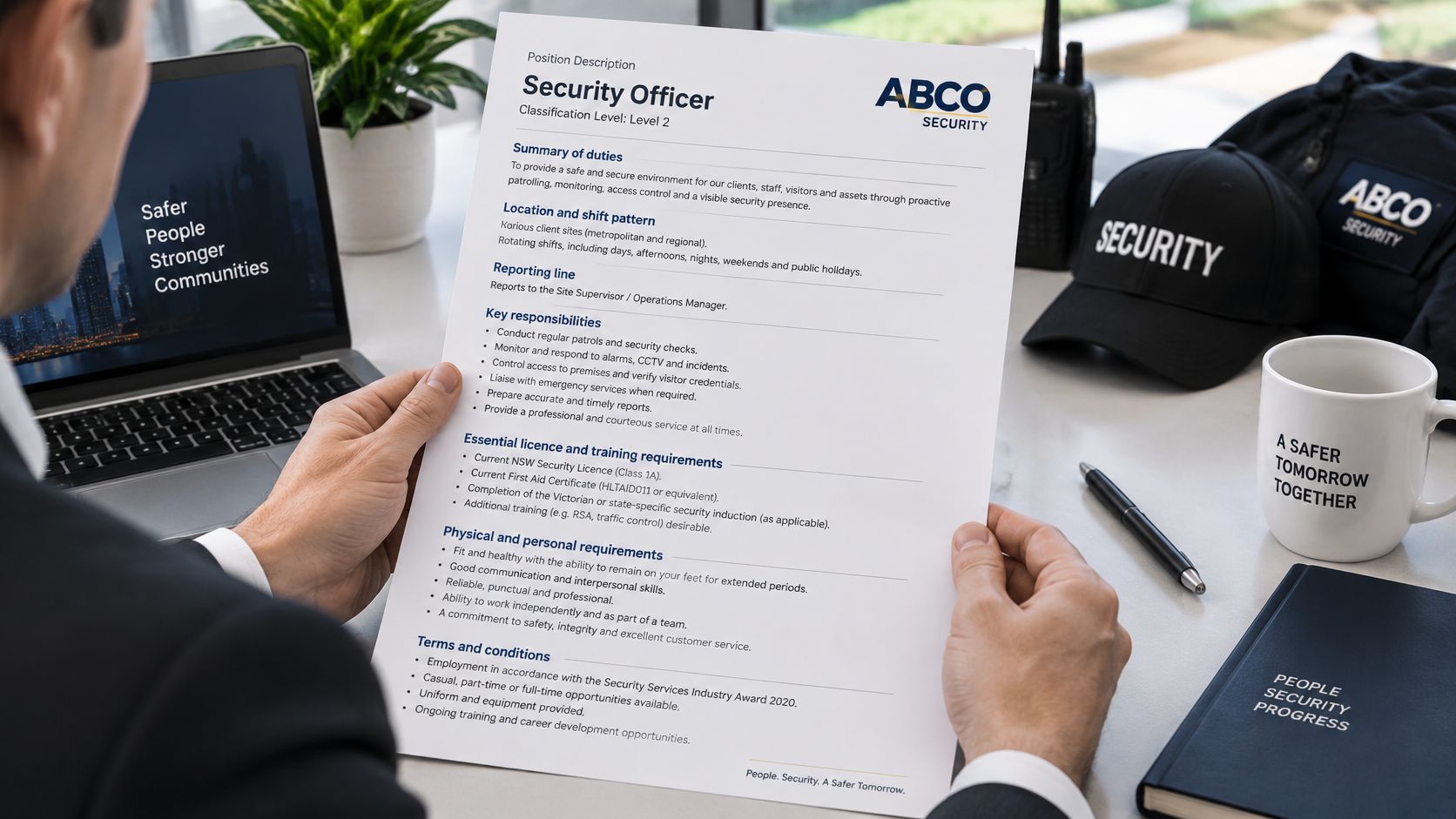 Security Officer Work Description: Duties and Licences 9 A person holding a printed job description document for a security officer position at ABCO Security.