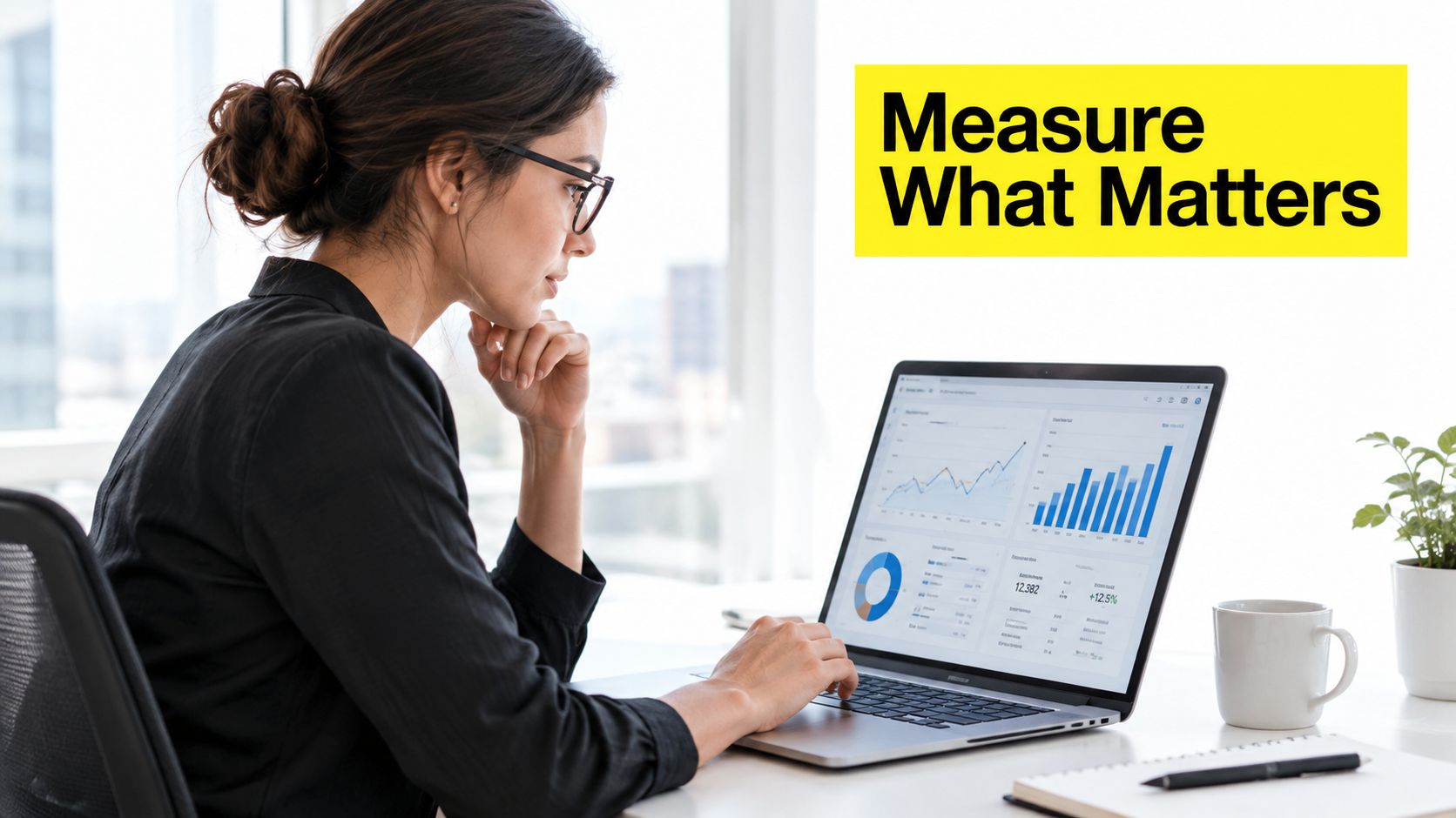 A professional woman in a bright office analyzing marketing dashboard data on her laptop screen.