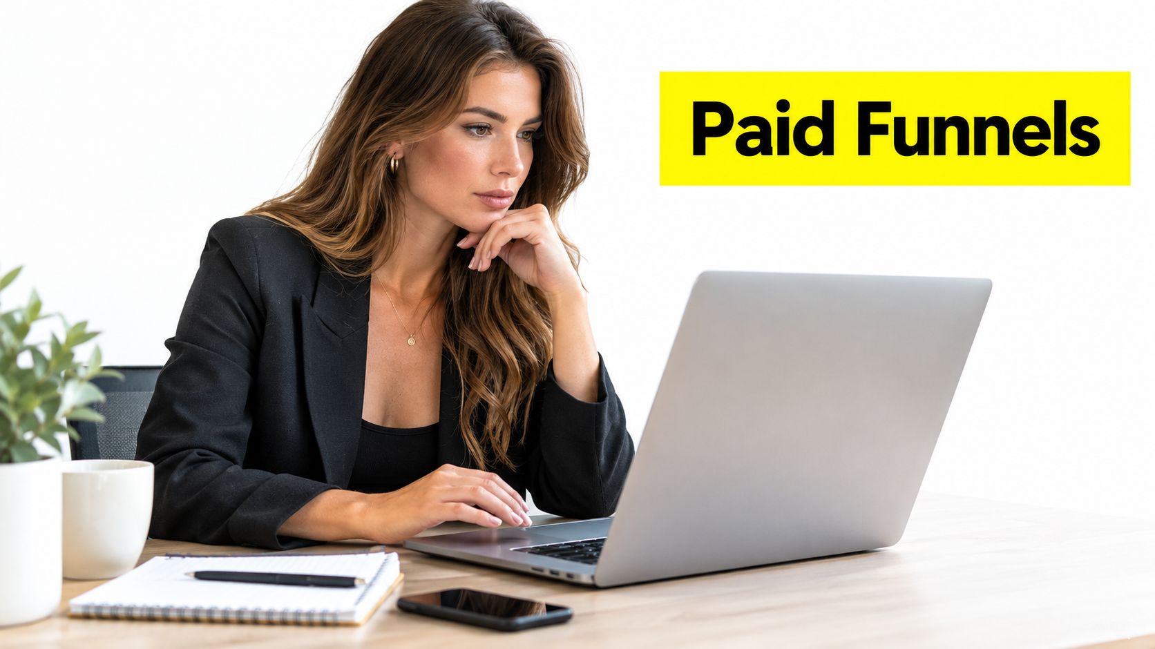 A professional woman working on a laptop at a desk with the text Paid Funnels nearby.