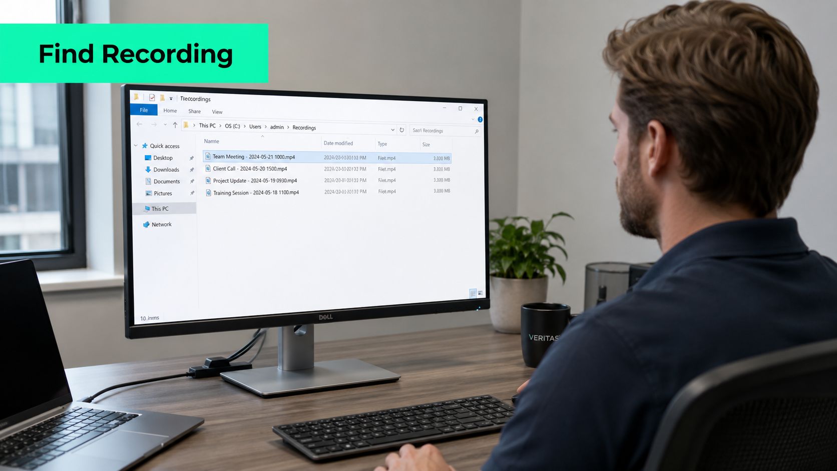 A professional man at a desk using a computer to search for video recordings in folders.