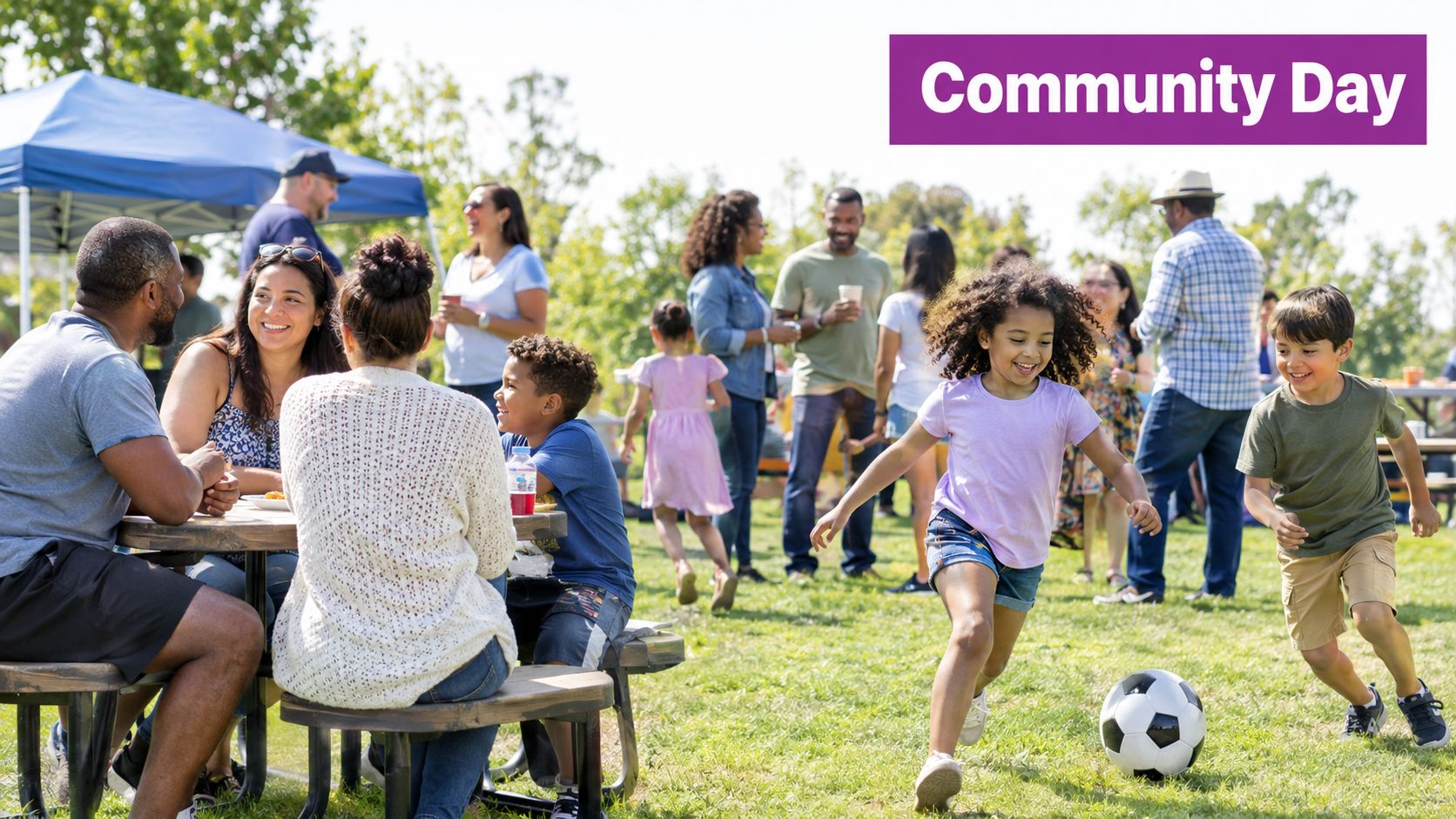 A diverse group of families enjoying a sunny community day picnic in a park with outdoor activities.