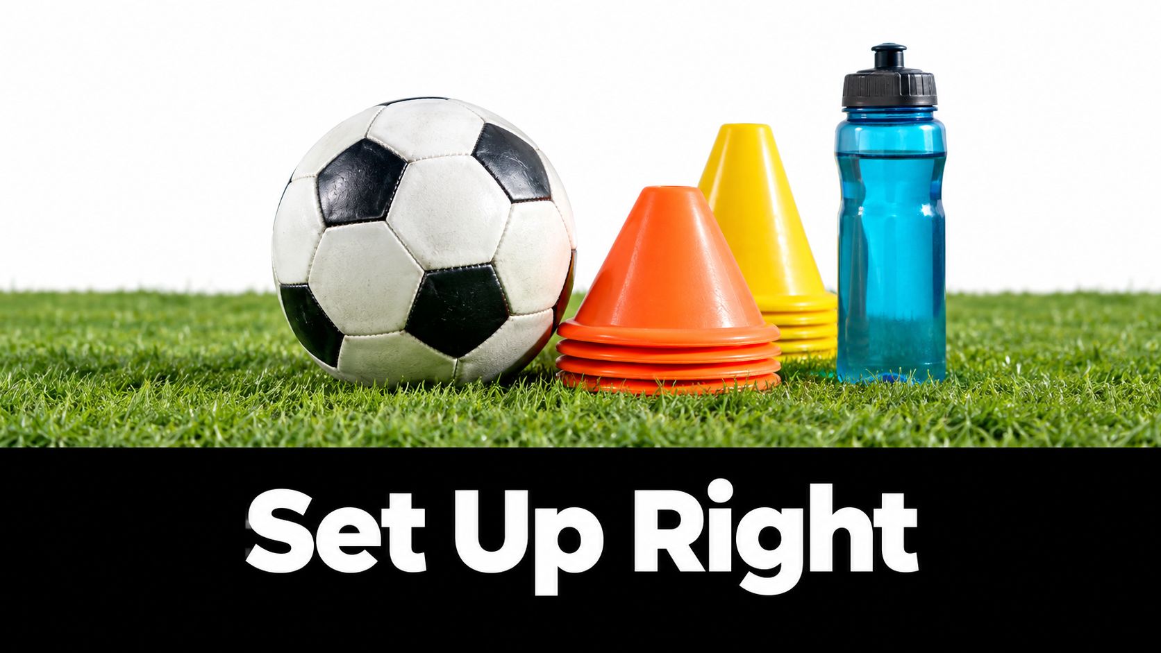A soccer ball, stacked orange and yellow cones, and a blue water bottle on green grass.