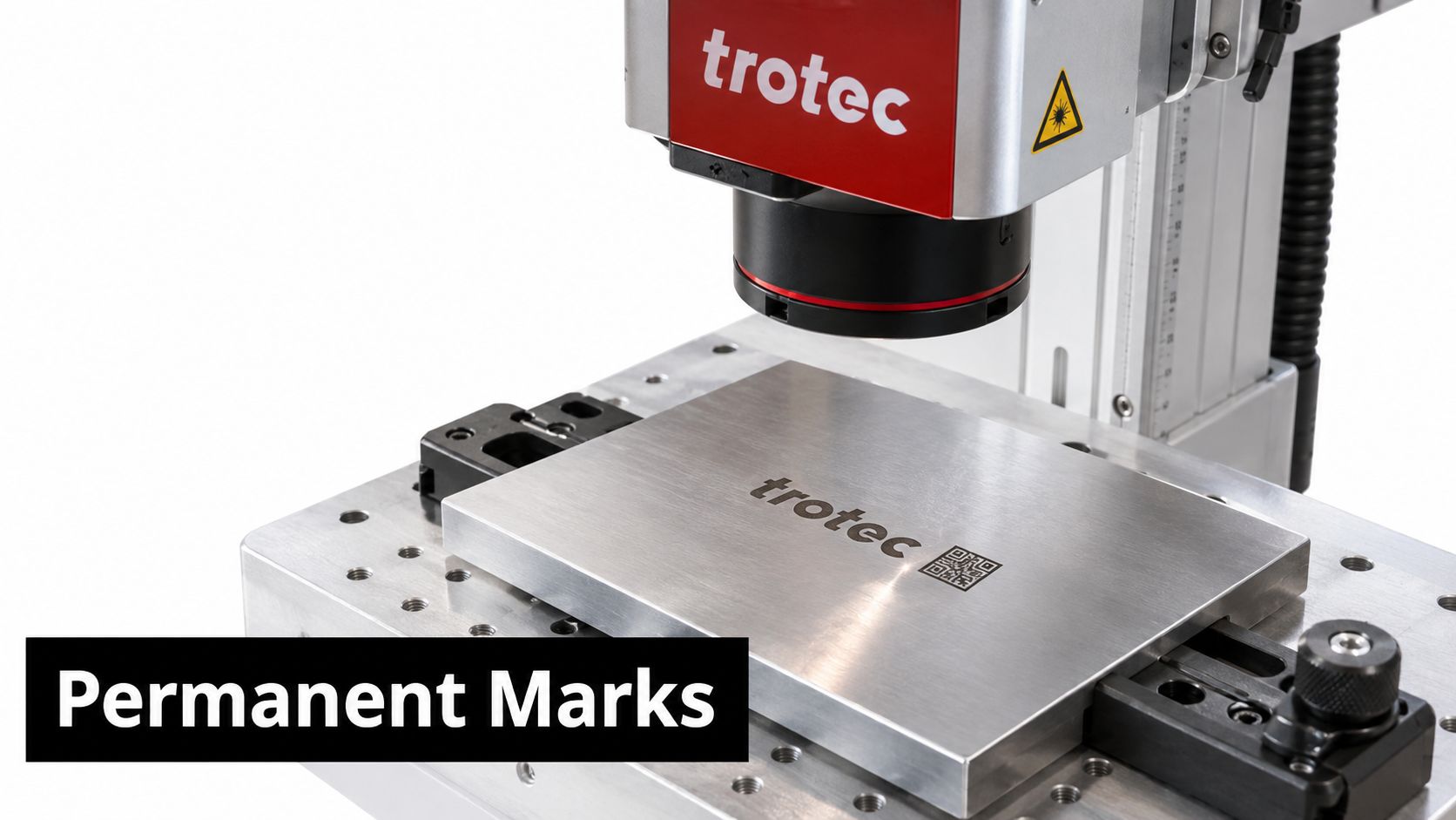 A professional Trotec laser marking machine engraving a permanent logo on a metallic plate surface.