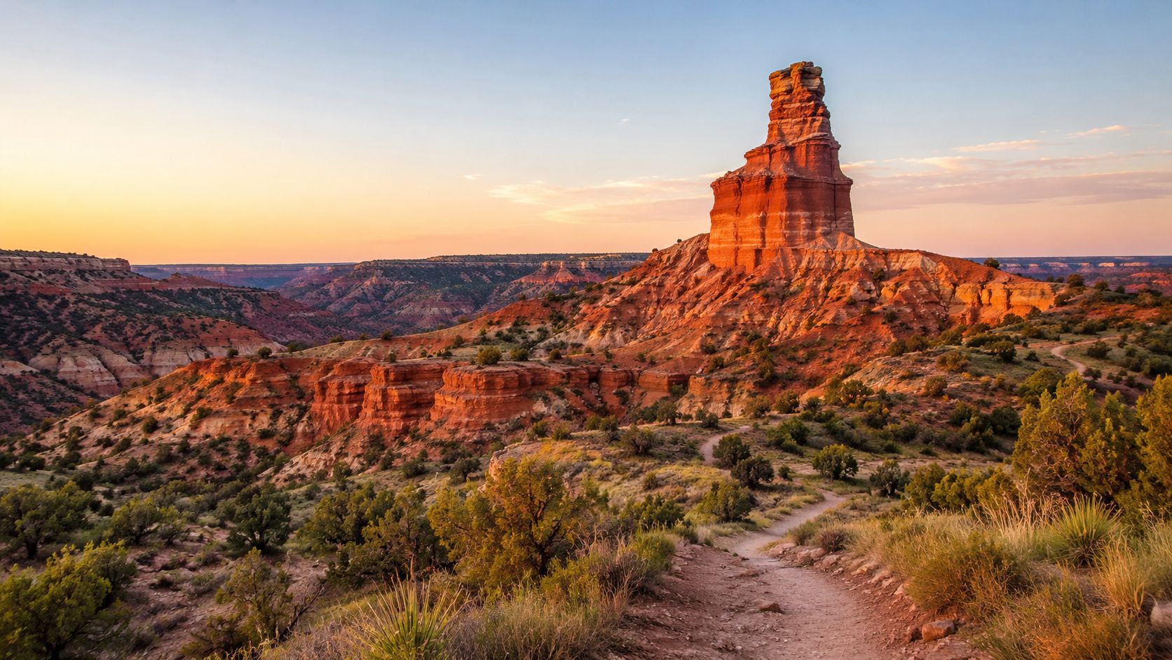 The iconic Lighthouse rock formation stands tall over the red canyon landscape of Palo Duro Canyon State Park.
